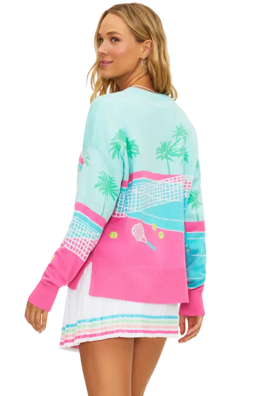 Woman wearing a colorful sweater and skirt with tennis-themed design on a white background